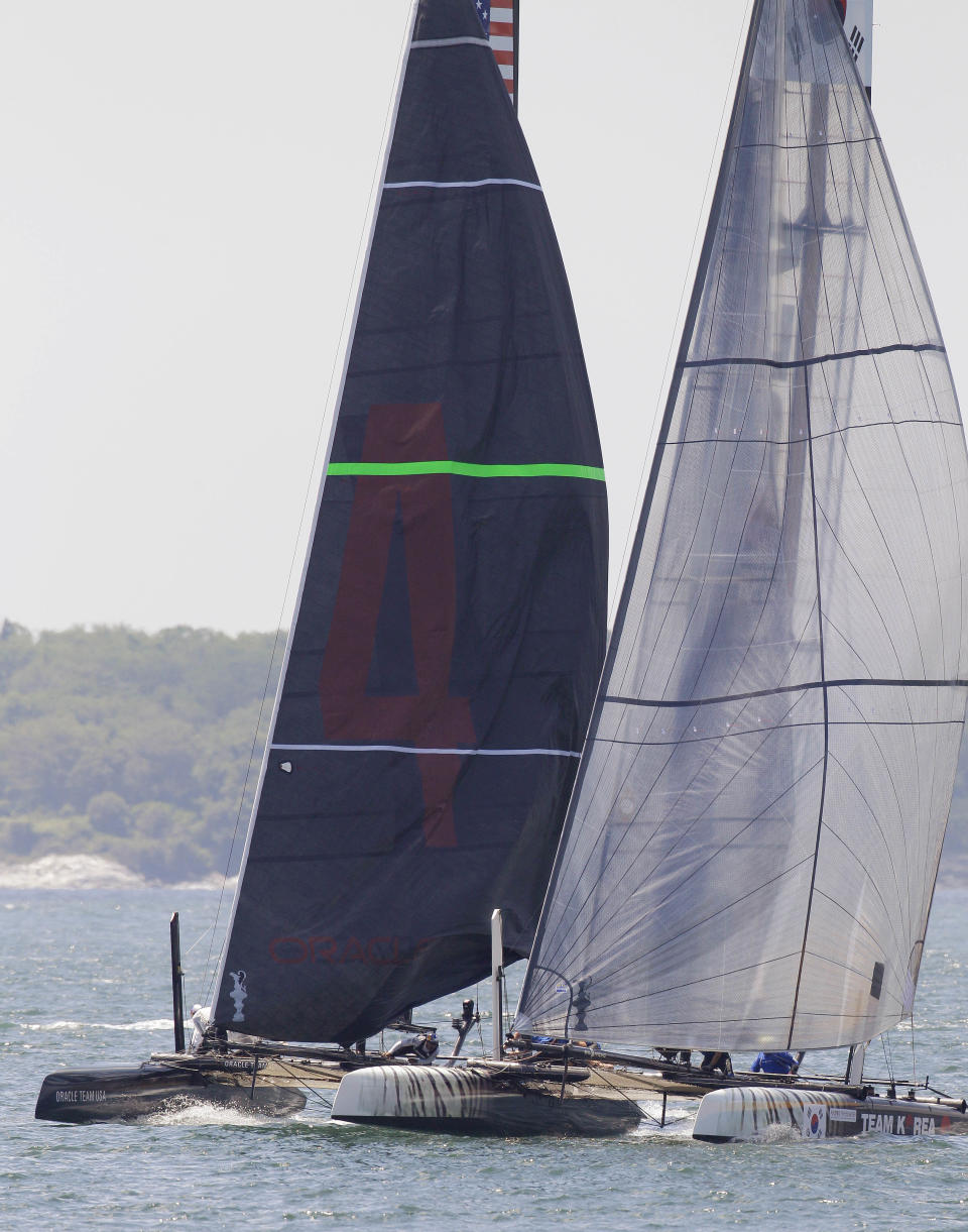 The Oracle Team USA Spithill boat, left, and the Team Korea boat head into the first turn of their match race during the first day of the America's Cup World Series regatta in Newport, R.I., Thursday, June 28, 2012. (AP Photo/Stephan Savoia)