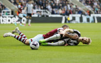 West Ham United's Vladimir Coufal, left, and Newcastle United's Anthony Gordon battle for the ball during the English Premier League soccer match between Newcastle United and West Ham at St. James' Park, Newcastle upon Tyne, England, Saturday March 30, 2024. (Richard Sellers/PA via AP)