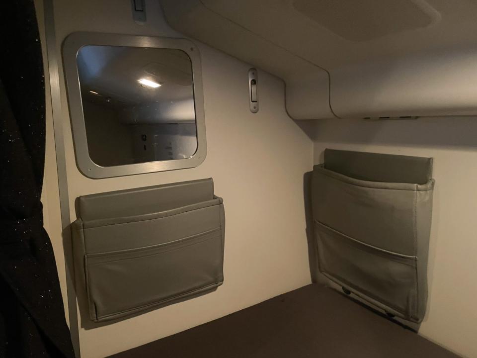 Each bed area has small storage compartments and a mirror.