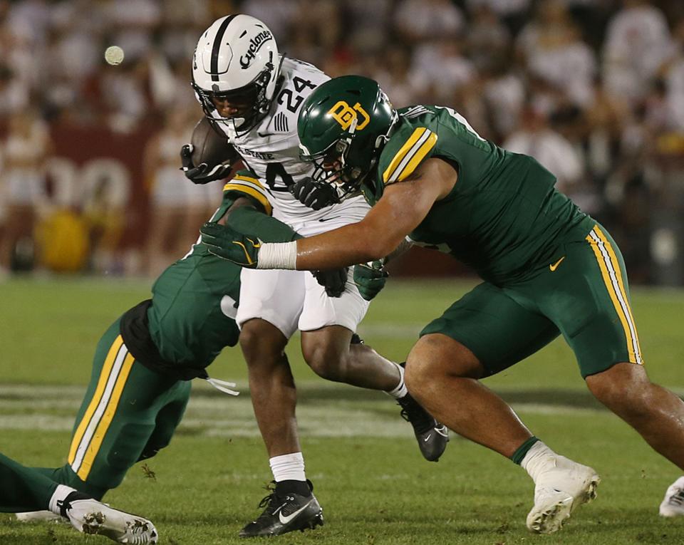 Iowa State Cyclones running back Abu Sama III (24) battles for a few yards as getting tackle by Baylor Bears defensive line Jackie Marshall (0) during the fourth quarter in the NCAA football at Jack Trice Stadium on Saturday, Oct. 5, 2024, in Ames, Iowa.