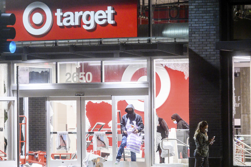 People leave a vandalized Target store in Oakland, Calif., on Saturday, May 30, 2020, during protests against the death of George Floyd, a handcuffed black man in police custody in Minneapolis. (AP Photo/Noah Berger)