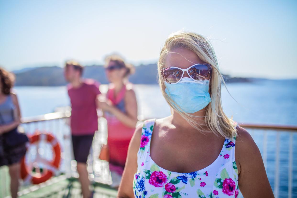 Blonde woman relaxing on cruise ship on summer day during Covid 19 pandemic