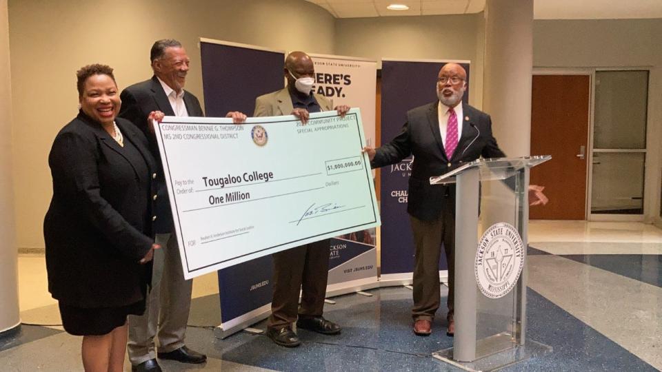 Tougaloo College President Carmen Walters left, stands with former Mississippi Supreme Court Judge Ruben V. Anderson, second from left, to receive a $1 million check from U.S. Rep Bennie Thompson, right, to support the college's Reuben V. Anderson Institute for Social Justice on Thursday, May 5, 2022.