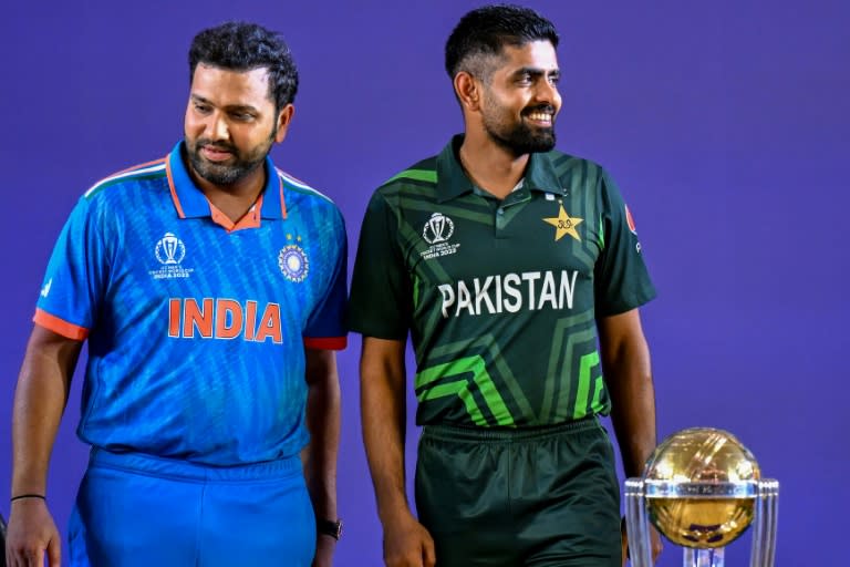 Eyes on the prize: India captain Rohit Sharma and Pakistan skipper Babar Azam stand beside the World Cup trophy in Ahmedabad on Wednesday (Punit PARANJPE)