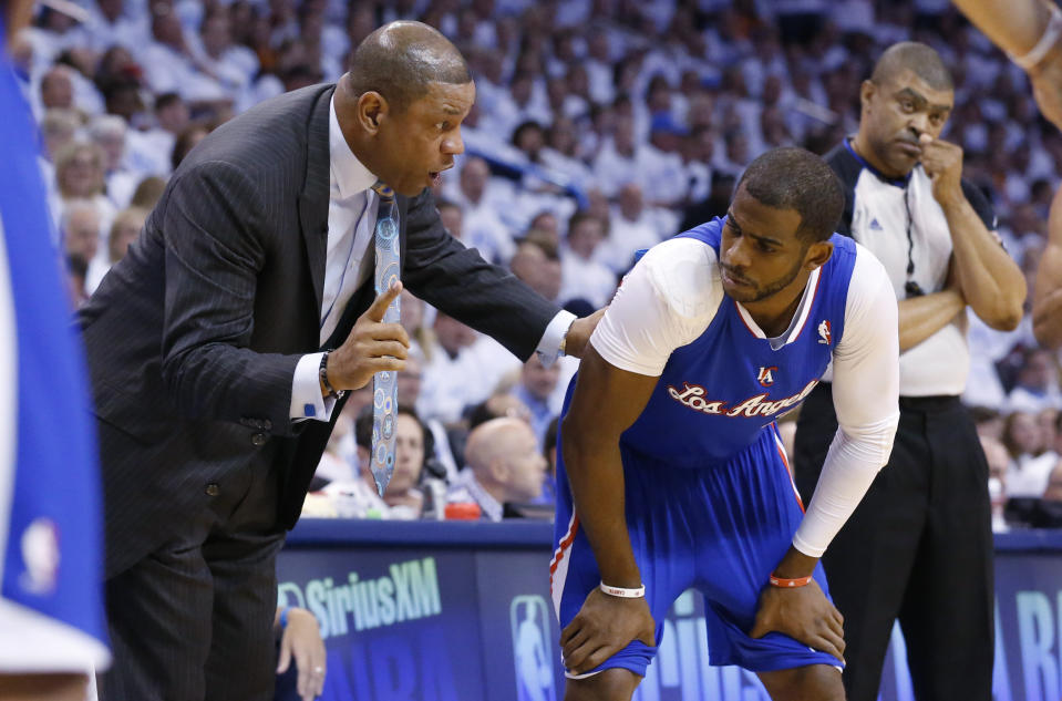 Los Angeles Clippers coach Doc Rivers, left, talks to guard Chris Paul in the first quarter of Game 5 of the Western Conference semifinal NBA basketball playoff series against the Oklahoma City Thunder, in Oklahoma City, Tuesday, May 13, 2014. (AP Photo)