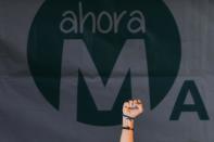 Spanish Euro Deputy and leader of left-wing party Podemos Pablo Iglesias raises his fist during a press conference following the results in Spain's municipal and regional elections in Madrid on May 24, 2015