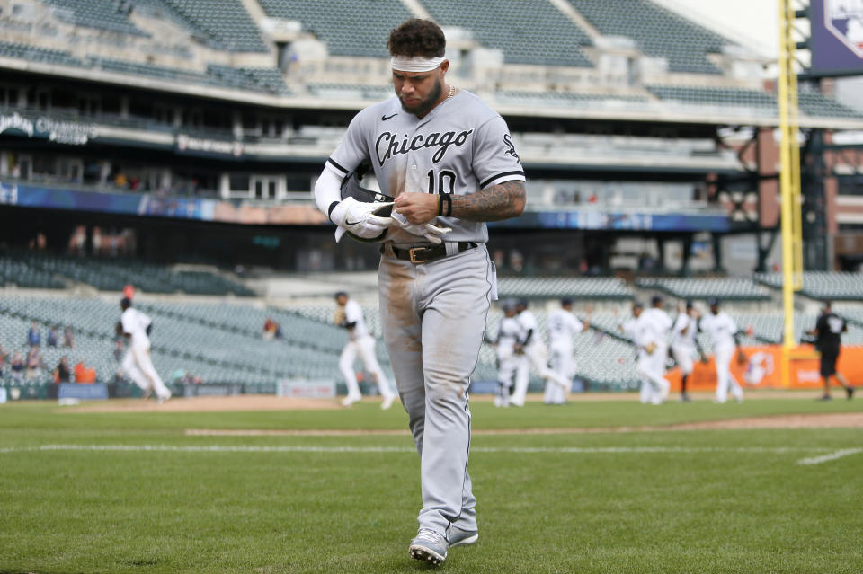 Chicago White Sox's Yoan Moncada walks off the field as the Detroit tigers celebrate a 5-3 win in a baseball game Tuesday, Sept. 21, 2021, in Detroit. (AP Photo/Duane Burleson)