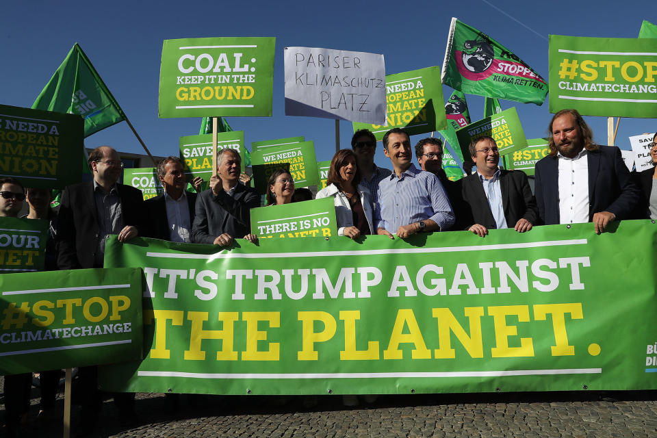 <p>Members of the German Greens Party (Buendnis 90/Die Gruenen), including party co-heads Katrin Goering-Eckardt and Cem Oezdemir (c), protest outside the U.S. Embassy against the announcement by U.S. President Donald Trump the day before that he will pull the USA out of the Paris Agreement on June 2, 2017 in Berlin, Germany. (Sean Gallup/Getty Images) </p>