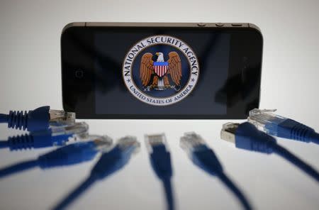 An illustration picture shows the logo of the U.S. National Security Agency on the display of an iPhone in Berlin, June 7, 2013. REUTERS/Pawel Kopczynski