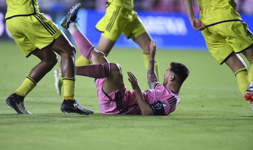 Inter Miami forward Lionel Messi is tripped by the Nashville SC defense during the first half of a CONCACAF Champions Cup soccer match, Wednesday, March 13, 2024, in Fort Lauderdale, Fla. (AP Photo/Michael Laughlin)