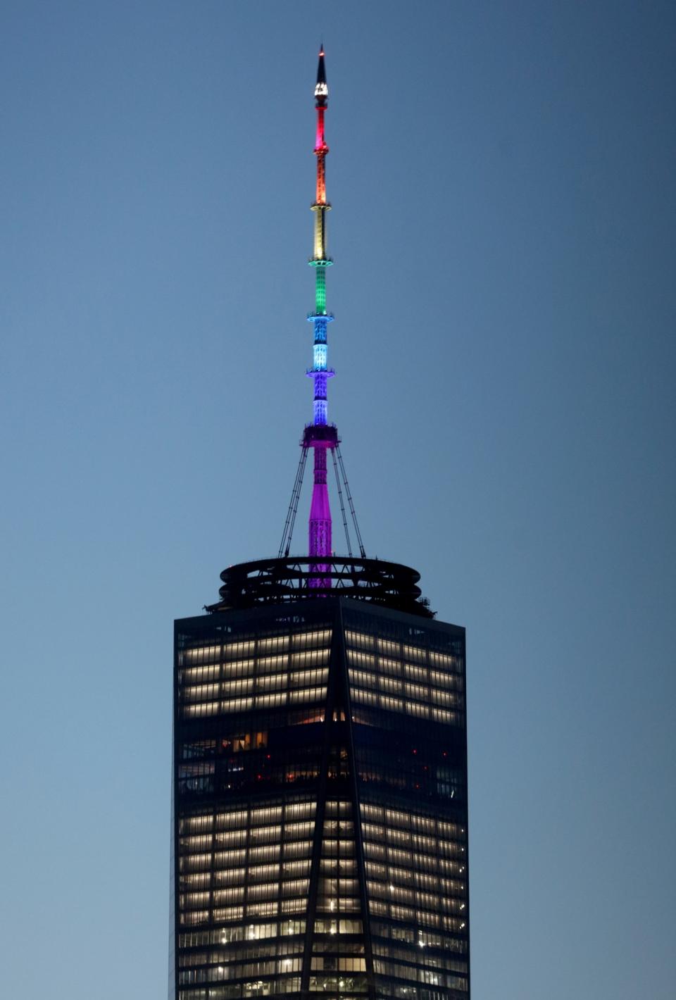 <p>One World Trade Center is lit up in the colors of the pride flag to honor the victims of the Orlando mass shooting, June 12, 2016. (Andrew Gombert/EPA) </p>