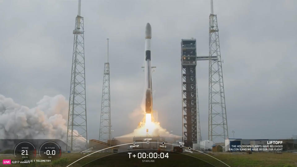 a black-and-white spacex falcon 9 rocket launches into a cloudy sky.