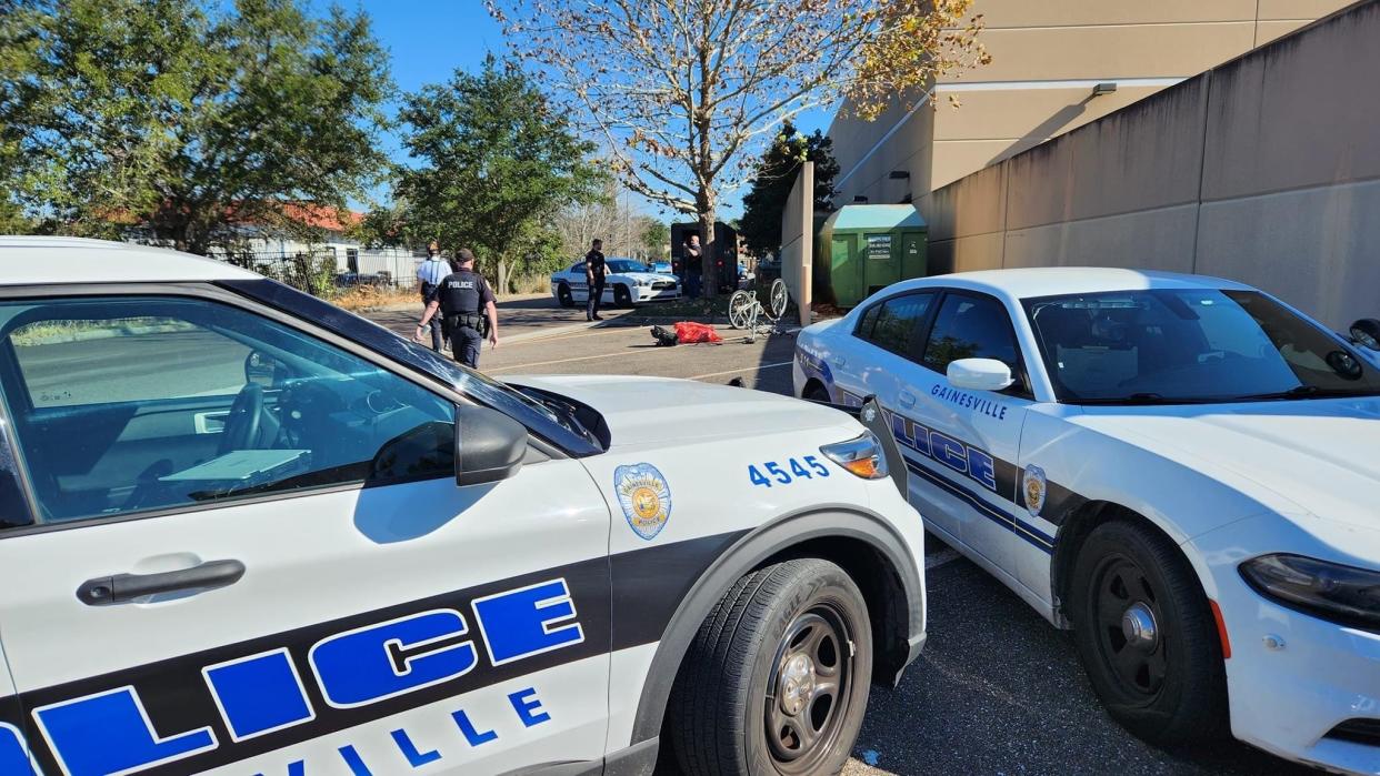 Gainesville Police Department officers investigate the scene of a fatal hit-and-run involving a bicyclist in the 3500 block of Southwest Archer Road.