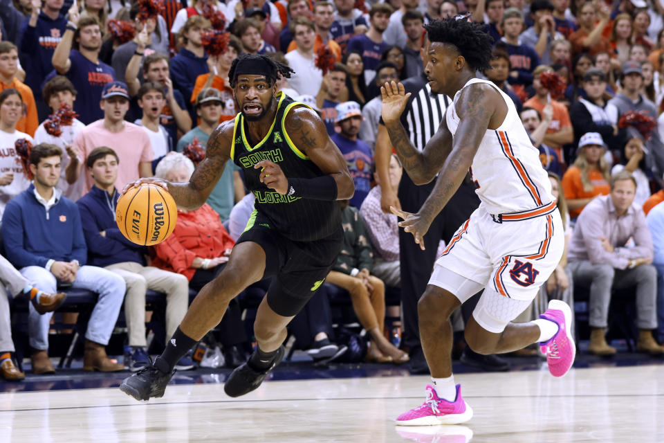 South Florida guard Selton Miguel, left, drives around Auburn guard Zep Jasper during the first half of an NCAA college basketball game Friday, Nov. 11, 2022, in Auburn, Ala. (AP Photo/Butch Dill)