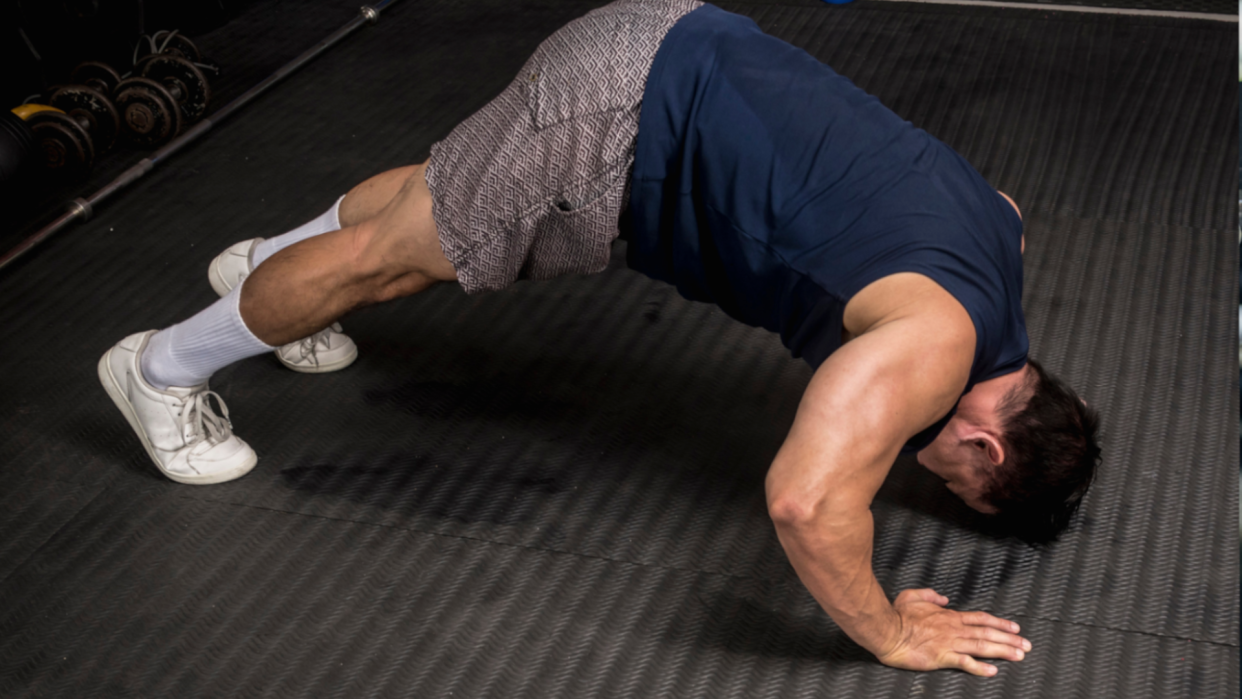  Man doing pike push up. 