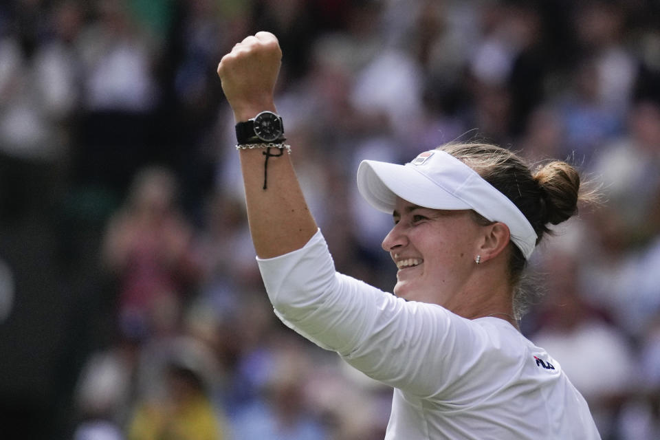 Barbora Krejcikova of the Czech Republic celebrates after defeating Jelena Ostapenko of Latvia in their quarterfinal match at the Wimbledon tennis championships in London, Wednesday, July 10, 2024. (AP Photo/Mosa'ab Elshamy)