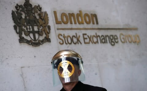 A man takes part in a demonstration at the London stock exchange during an Extinction Rebellion protest - Credit: Simon Dawson/Reuters