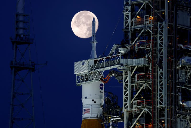 FILE PHOTO: A full moon, known as the "Strawberry Moon" is shown with NASA’s next-generation moon rocket, the Space Launch System (SLS) Artemis 1, at the Kennedy Space Center in Cape Canaveral