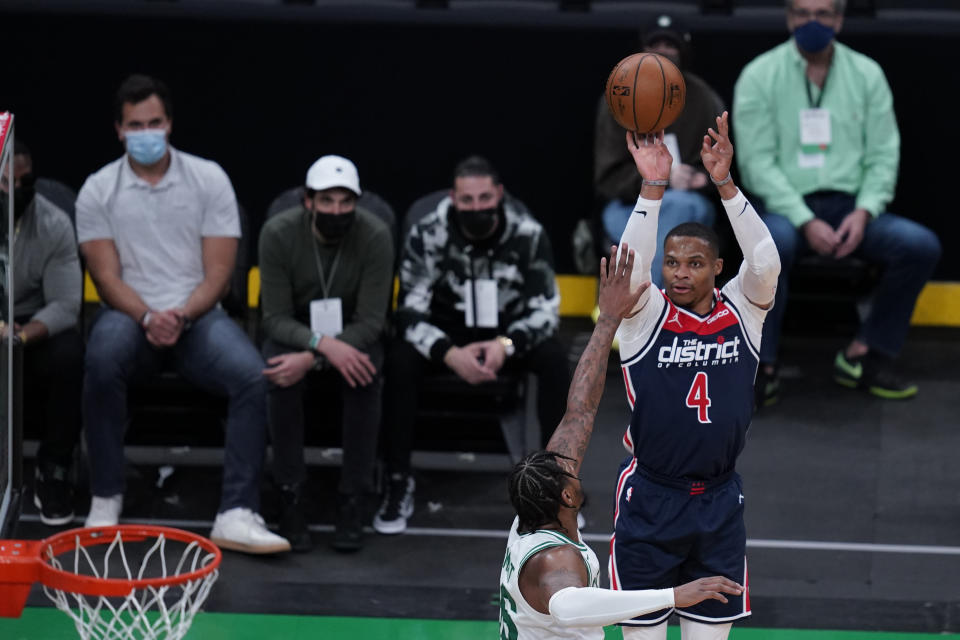 Fans wearing protective masks watch as Washington Wizards guard Russell Westbrook (4) takes a shot during the first half of an NBA basketball Eastern Conference Play-in game, Tuesday, May 18, 2021, in Boston. (AP Photo/Charles Krupa)