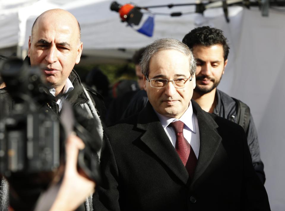 Syria's Deputy Foreign Minister Faisal Mekdad (C), who is a part of a Syrian government delegation, arrives for a meeting with U.N.-Arab League envoy for Syria Lakhdar Brahimi (not seen) at a U.N. office in Geneva January 24, 2014. International mediator Brahimi ended talks with the Syrian government delegation on Friday after less than an hour, two security officials said. (REUTERS/Jamal Saidi)