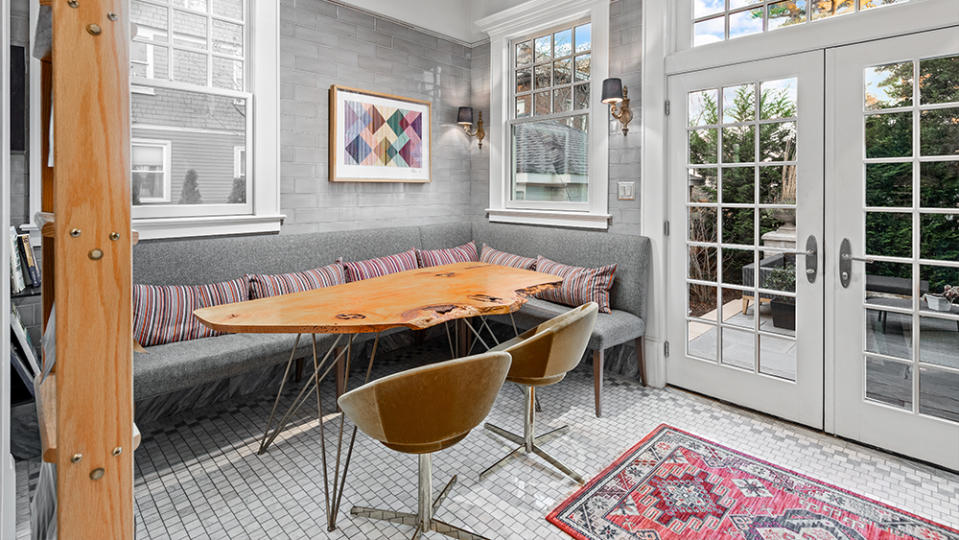 A light-filled breakfast nook leading to a terrace.