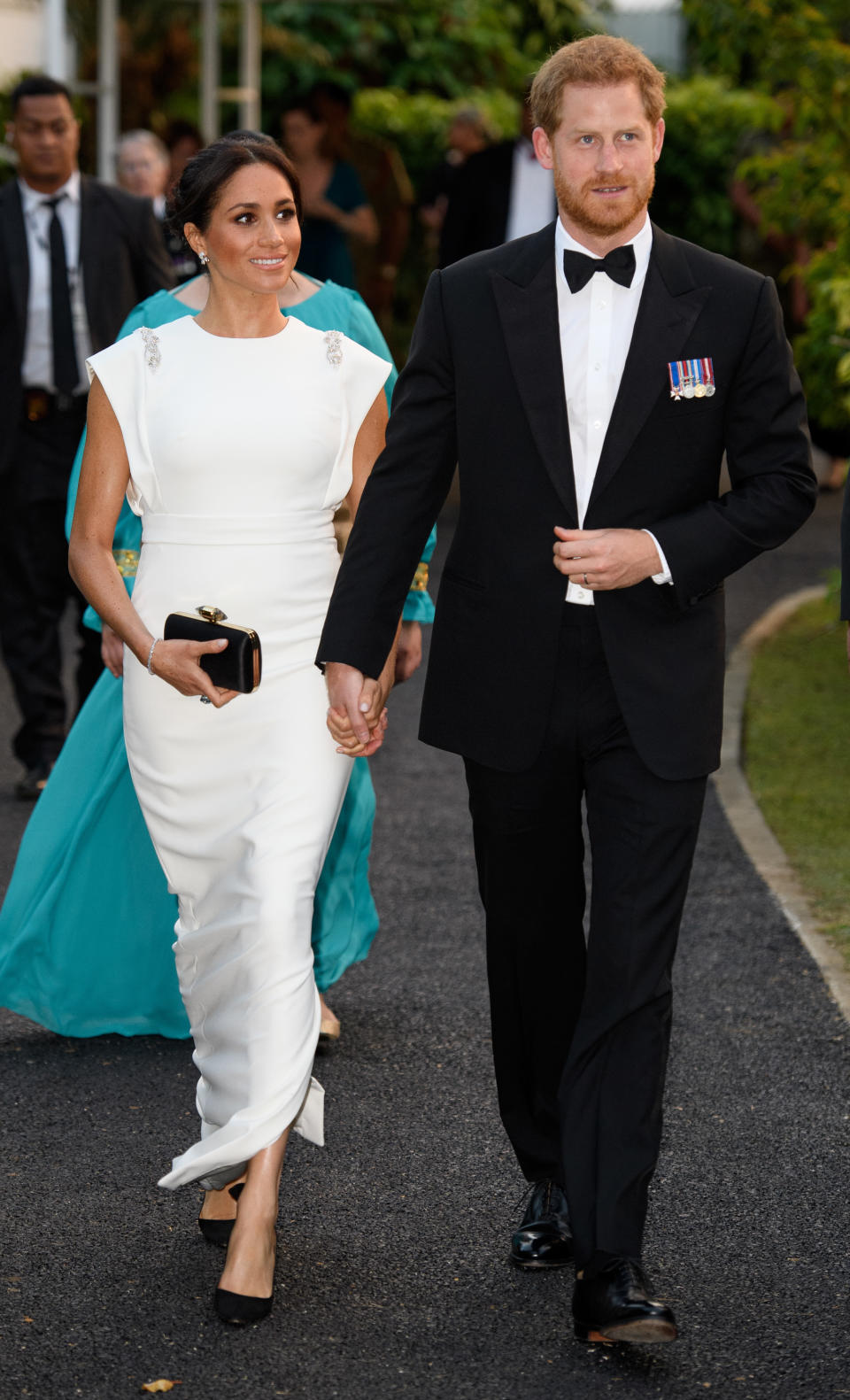 <p>For an evening reception and dinner in Tonga, the Duchess opted for a more formal look. The 37-year-old dressed her bump in a white gown by Theia Couture finished with Aquazzura shoes, Birks earrings and her go-to Givenchy clutch. In a touching nod to Princess Diana, the Duchess wore the late royal’s aquamarine ring. <em>[Photo: Getty]</em> </p>