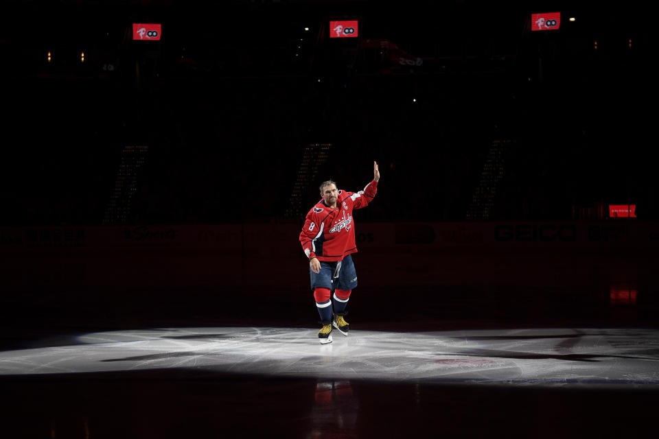 Washington Capitals left wing Alex Ovechkin, of Russia, waves to the crowd before a ceremony honoring Ovechkin for his 700th goal, before the team's NHL hockey game against the Winnipeg Jets, Tuesday, Feb. 25, 2020, in Washington. (AP Photo/Nick Wass)