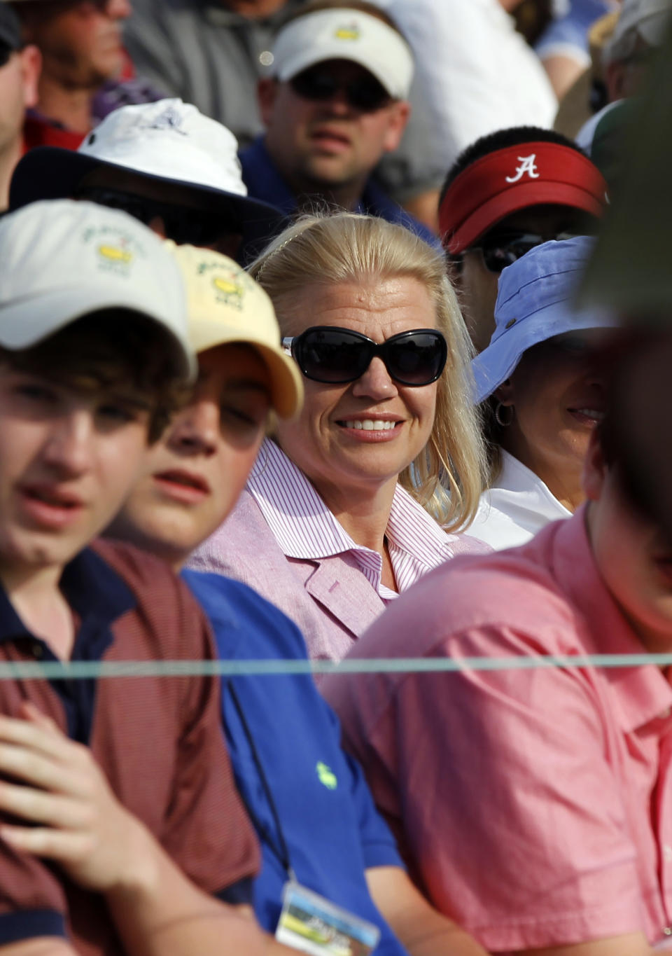 IBM CEO Virginia Rometty watches the fourth round of the Masters golf tournament from the gallery on the 18th green Sunday, April 8, 2012, in Augusta, Ga. (AP Photo/Chris O'Meara)