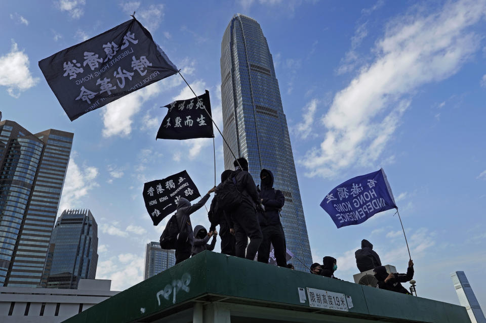 Protesters wave flags that read "Hong Kong Independence" during a rally in Hong Kong, Sunday, Jan. 12, 2020. More than a thousand people attended a Sunday rally in Hong Kong to urge people and governments abroad to support the territory's pro-democracy movement and oppose China's ruling Communist Party. (AP Photo/Vincent Yu)