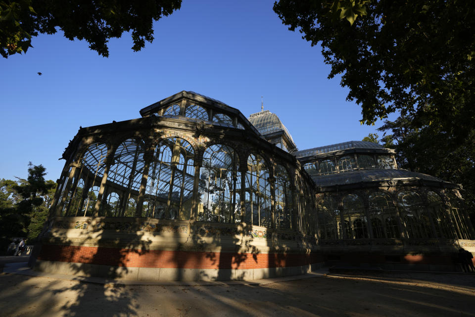 The Glass Palace stands shaded by trees in the Retiro park in Madrid, Spain, Thursday, July 22, 2021. Madrid's tree-lined Paseo del Prado boulevard and the adjoining Retiro park have been added to UNESCO's World Heritage list. The UNESCO World Heritage Committee backed the candidacy that highlighted the green area's introduction of nature into Spain's capital. (AP Photo/Paul White)