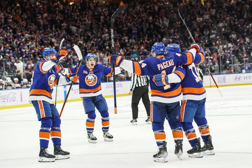 New York Islanders players celebrate after defeating the Columbus Blue Jackets during extra period of an NHL hockey game, Saturday, Nov. 12, 2022, in Elmont, N.Y. New York Islanders won 4-3. (AP Photo/Eduardo Munoz Alvarez)