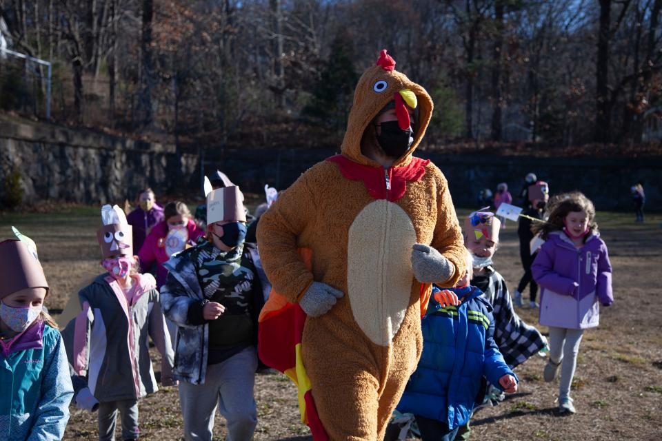 An Elm Street School teacher leads the second-graders during the Turkey Trot.