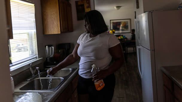PHOTO: Water runs from a faucet at Deneka Samuel's kitchen, while the city of Jackson is to go without reliable drinking water indefinitely after pumps at the water treatment plant failed, in Jackson, Miss., Sept. 1, 2022. (Carlos Barria/Reuters)