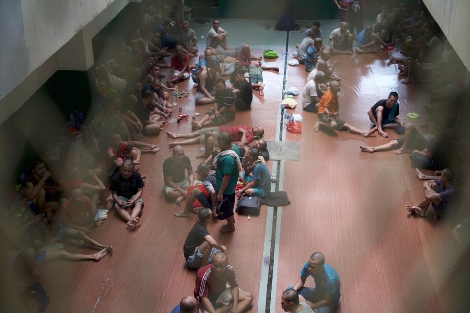 Inmates socialising during their mealtime in Cipinang Penitentiary Institution in Jakarta, Indonesia.