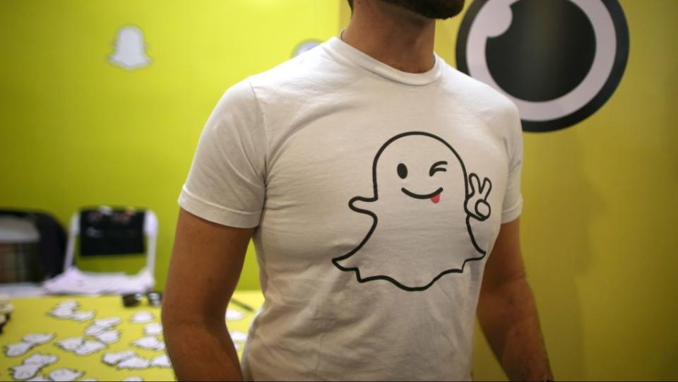 A recruiter for messaging app Snapchat talks to job seekers at a booth at TechFair LA, a technology job fair, in Los Angeles, California, U.S.