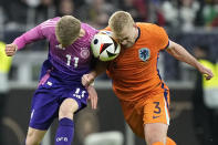 Netherlands' Matthijs de Ligt, right, challenges Germany's Chris Führich during the international friendly soccer match between Germany and Netherlands at the Deutsche Bank Park in Frankfurt, Germany on Tuesday, March 26, 2024. (AP Photo/Martin Meissner)