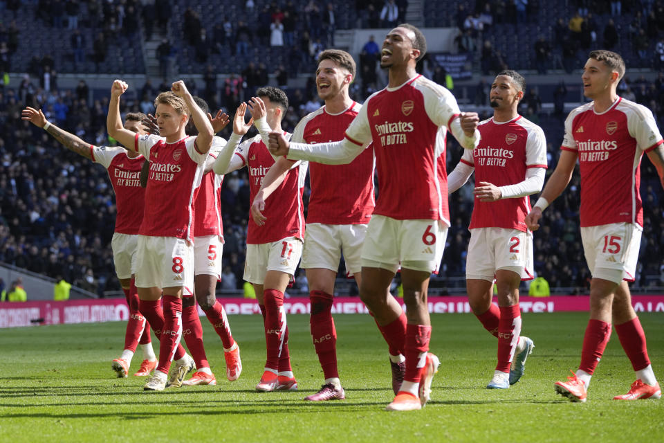 Arsenal's players celebrate at the end of the English Premier League soccer match between Tottenham Hotspur and Arsenal at the Tottenham Hotspur Stadium in London, England, Sunday, April 28, 2024. (AP Photo/Kin Cheung)