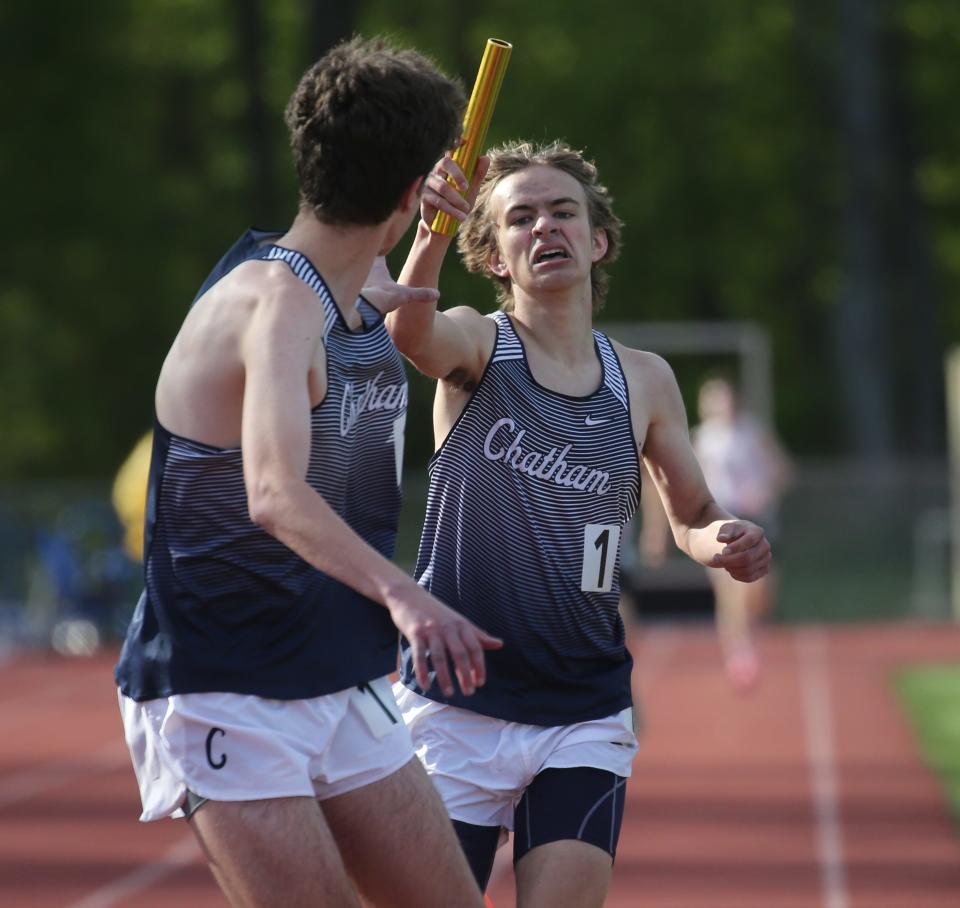 Ryan Beegle of Chatham Hans the baton to Alex Krack to run the second leg of the boys 4x1600 held during the Randolph Relays on May 12, 2021. The Chatham boys relay team ran the faster time this season in NJ with a time of 18:09:09.