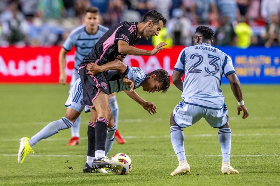 Inter Miami midfielder Sergio Busquets (5) attempts to steal the ball from Sporting Kansas City midfielder Felipe Hernández (21) during an MLS match at GEHA Field at Arrowhead Stadium, Saturday, April 13, 2024, in Kansas City.