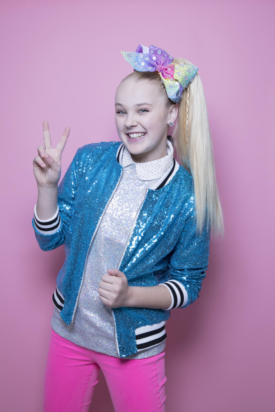 FILE - In this Dec. 10, 2018 file photo, JoJo Siwa poses for a portrait in New York. Stay-at-home orders, traveling fears and the cancellation of sporting events, concerts and theme parks have forced the Make-a-Wish foundation to come to a stand-still, leaving young people’s requests in holding patterns. The charity has introduced “Messages of Hope,” encouraging the public and celebrities to record inspiring messages and upload them to social media, and so far, stars like Siwa have already participated. (Photo by Amy Sussman/Invision/AP, File)