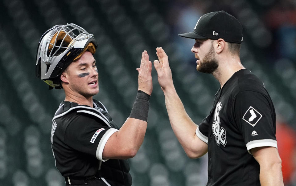 Chicago White Sox catcher James McCann, left, celebrates with starting pitcher Lucas Giolito after the team's baseball game against the Houston Astros Thursday, May 23, 2019, in Houston. Giolito threw a four-hitter as the White Sox won 4-0. (AP Photo/David J. Phillip)