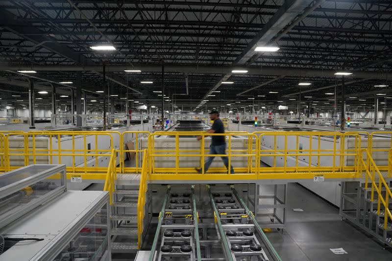 FILE PHOTO: Employees work on solar panels at the QCells solar manufacturing factory in Dalton