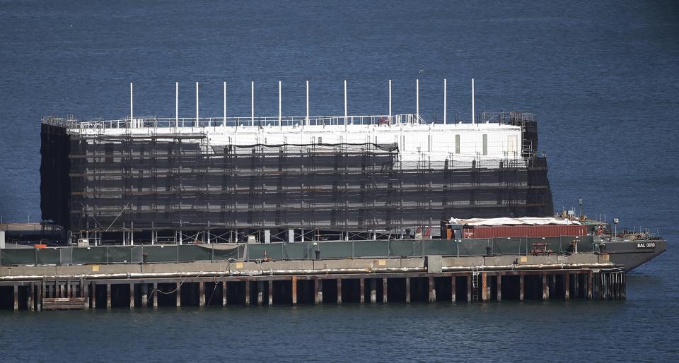 A barge built with four levels of shipping containers is seen at Pier 1 at Treasure Island in San Francisco, California October 28, 2013. How badly does Google want to keep under wraps a mysterious project taking shape on a barge in San Francisco Bay? Badly enough to require U.S. government officials to sign confidentiality agreements. REUTERS/Stephen Lam (UNITED STATES - Tags: SCIENCE TECHNOLOGY BUSINESS)