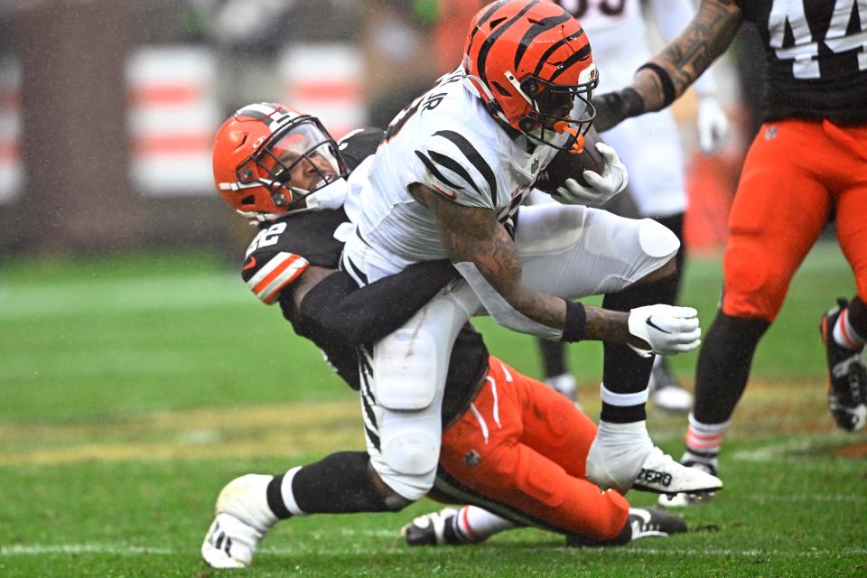 Cincinnati Bengals tight end Irv Smith Jr., right, is stopped by Cleveland Browns safety Grant Delpit (22) after making a catch on Sept. 10 in Cleveland.