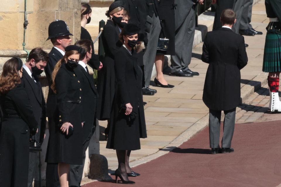 Britain's Catherine, Duchess of Cambridge (R) and members of the Royal family stand outside St George's Chapel for the funeral service of Britain's Prince Philip, Duke of Edinburgh in Windsor Castle in Windsor, west of London, on April 17, 2021. - Philip, who was married to Queen Elizabeth II for 73 years, died on April 9 aged 99 just weeks after a month-long stay in hospital for treatment to a heart condition and an infection. (Photo by HANNAH MCKAY / various sources / AFP) (Photo by HANNAH MCKAY/AFP via Getty Images)