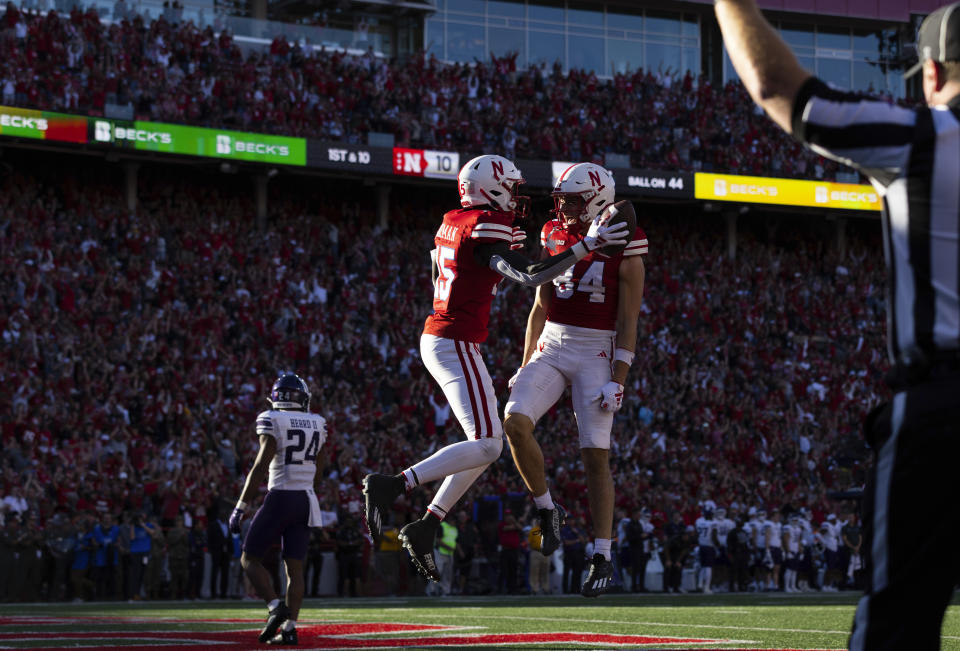 Nebraska's Malachi Coleman (15) celebrates with Alex Bullock (84) after catching a touchdown pass against Northwestern during the second half of an NCAA college football game Saturday, Oct. 21, 2023, in Lincoln, Neb. (AP Photo/Rebecca S. Gratz)