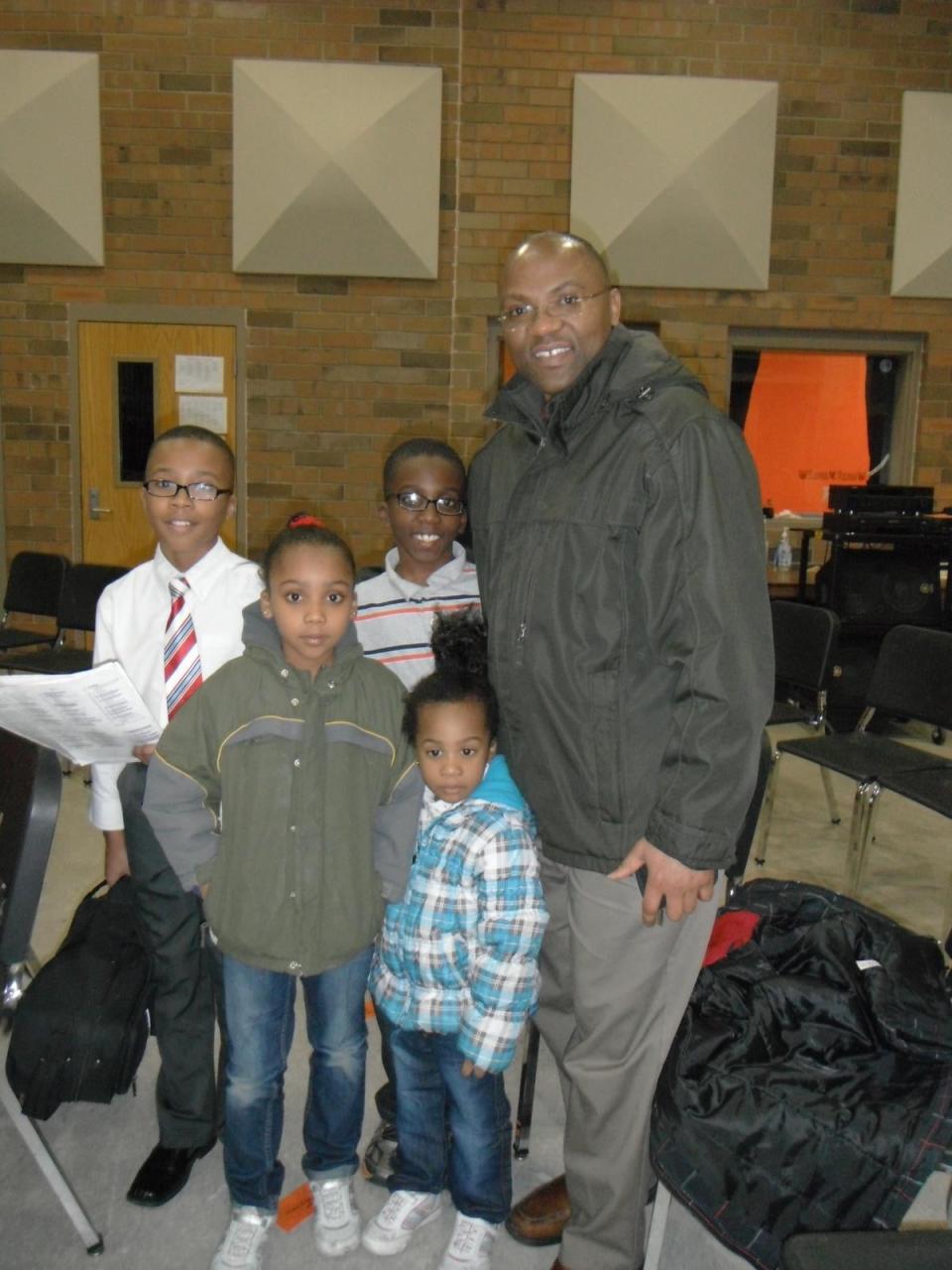 Eric Nshimiye poses with his four children, who are now teenagers and older; the family have issued a statement insisting upon his innocence and claiming allegations are fabricated (Nshimiye Family)