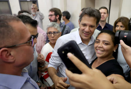 Fernando Haddad, presidential candidate of Brazil's leftist Workers' Party (PT), takes a selfie after a debate at the engineers club in Rio de Janeiro, Brazil October 19, 2018. REUTERS/Ricardo Moraes