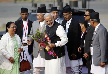 India's Prime Minister Narendra Modi (C) receives a bouquet upon his arrival for the 18th South Asian Association for Regional Cooperation (SAARC) summit in Kathmandu November 25, 2014. REUTERS/Navesh Chitrakar