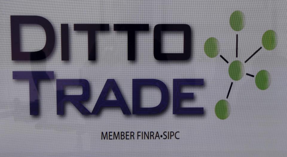 In this Sept. 12, 2012, photo, the Ditto Trade logo is seen in the company's his offices in Los Angeles. Ditto Trade is a new online brokerage firm where one can attach their stock portfolio to that of person they trust, so that when they make a trade, so will you. (AP Photo/Reed Saxon)